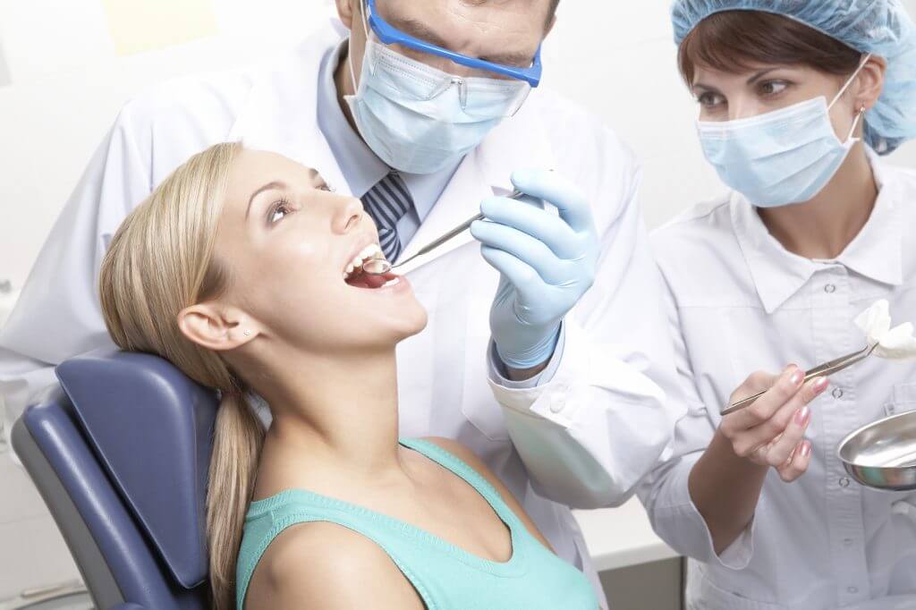 Dentist examining teeth